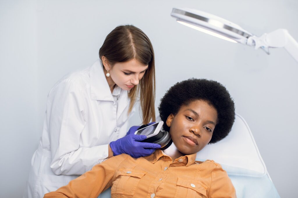 Young african american woman client lying on the couch in modern dermatology clinic having face.jpg